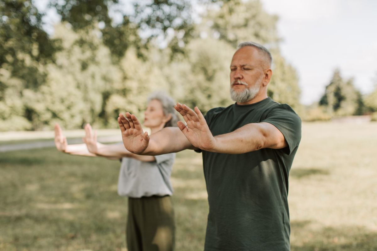 People practicing Tai Chi in a park