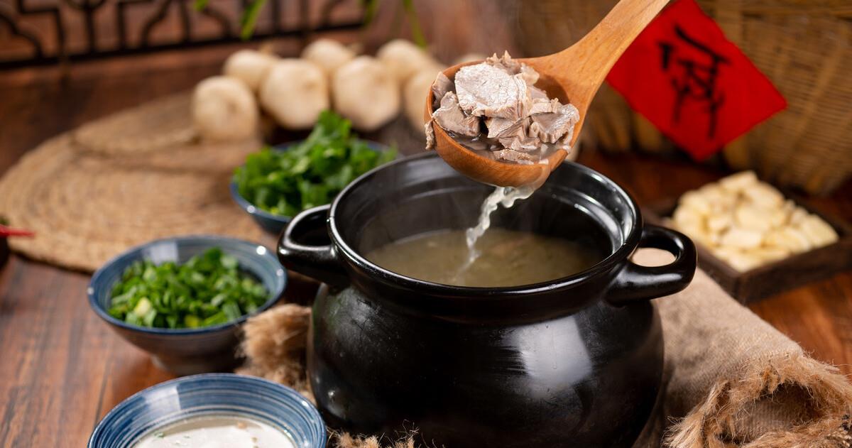 砂锅中翻滚的羊肉汤特写，热气腾腾
