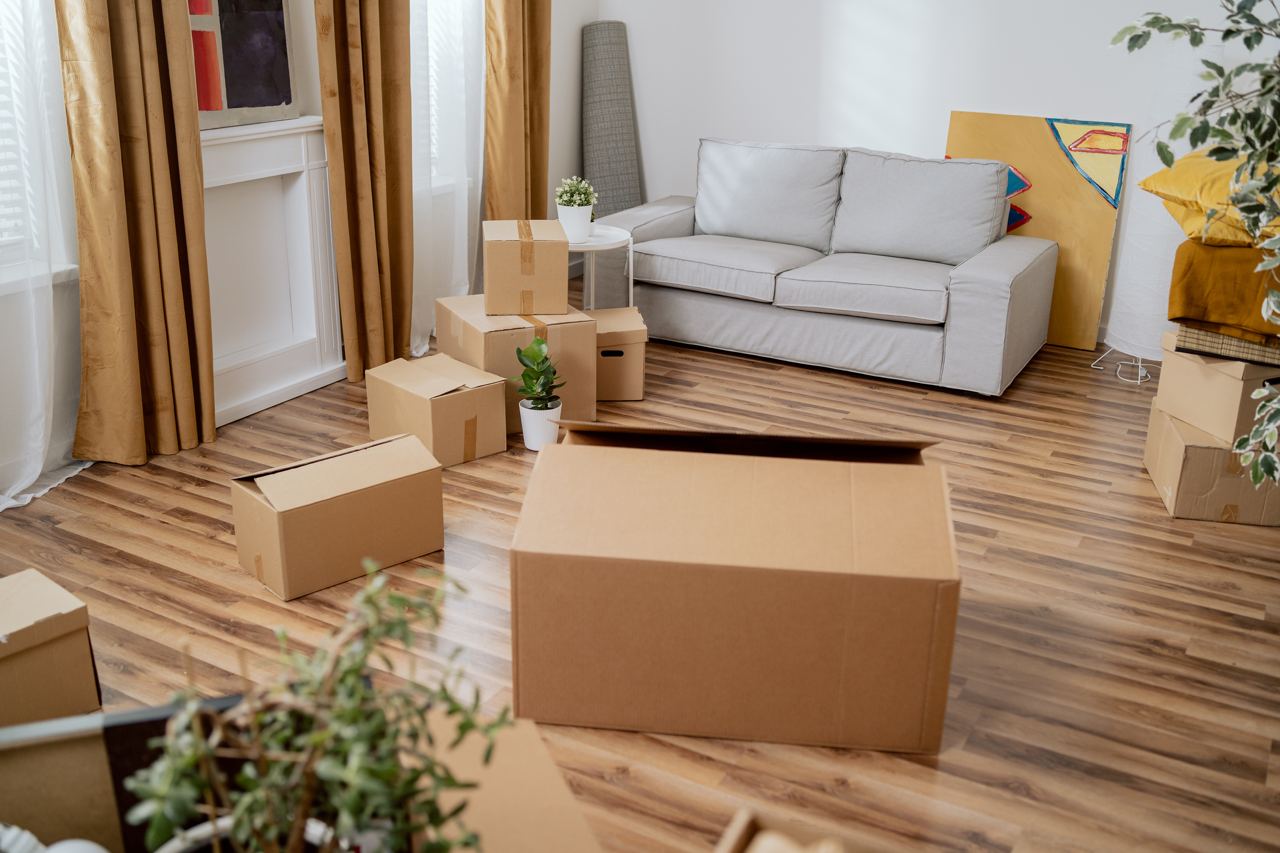 Family members packing and organizing belongings in the living room before moving